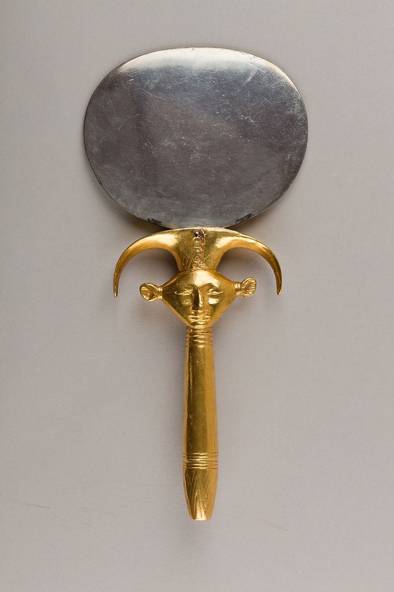An ancient Egyptian silver-and-gold mirror with a Hathor-emblem handle