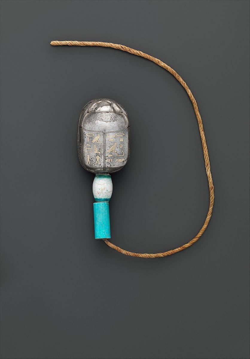 An ancient Egyptian silver scarab of the storehouse overseer Wah