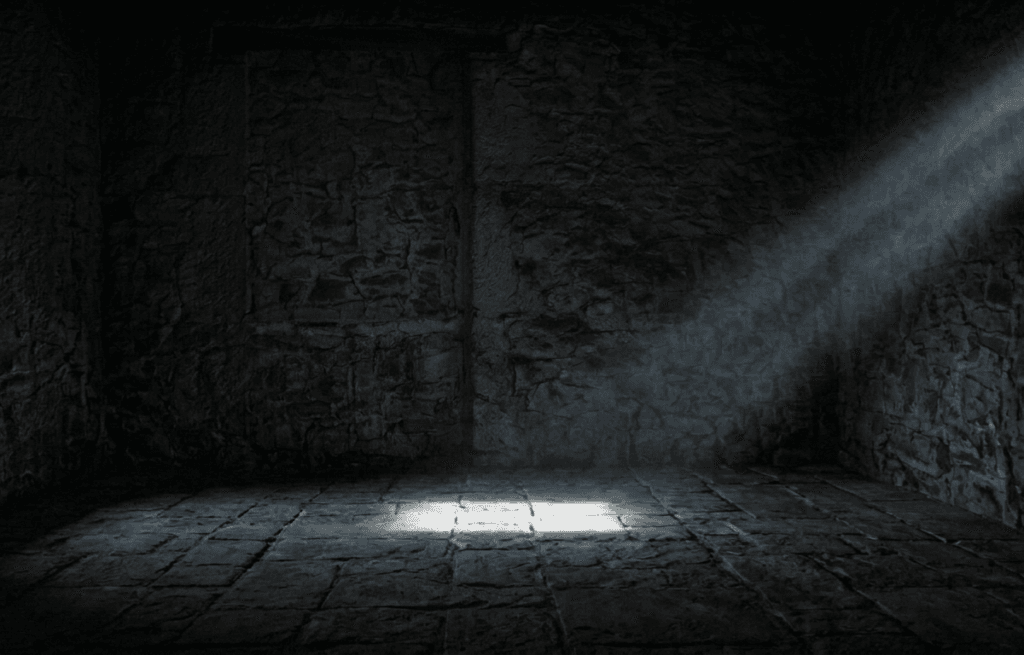 A narrow beam of light shining into surrounding darkness
